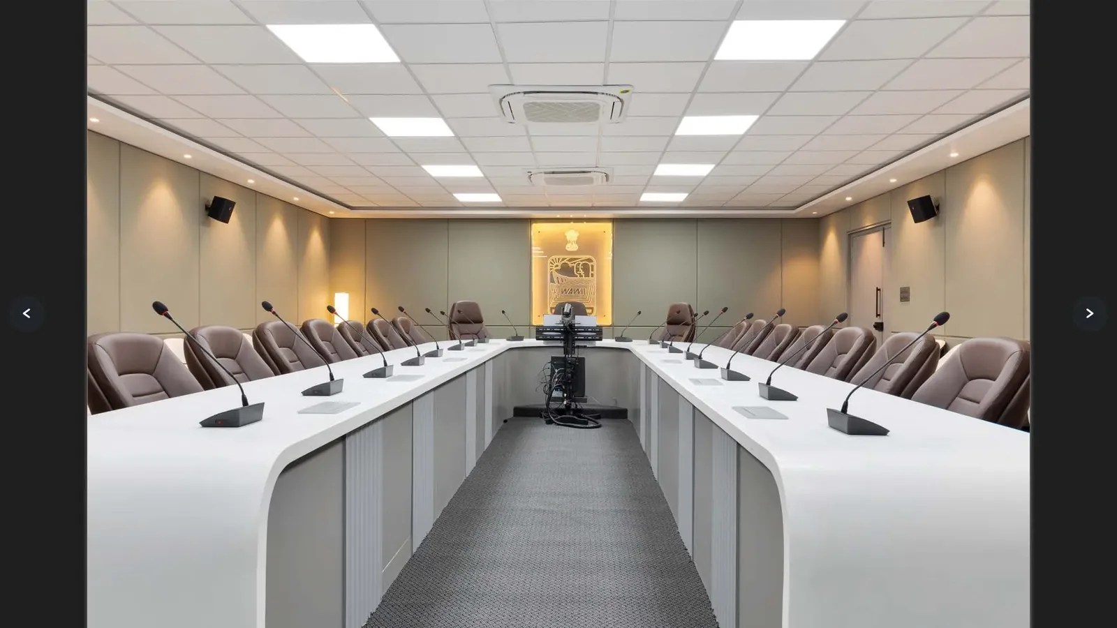 Conference hall with panelled acoustic walls and a large display